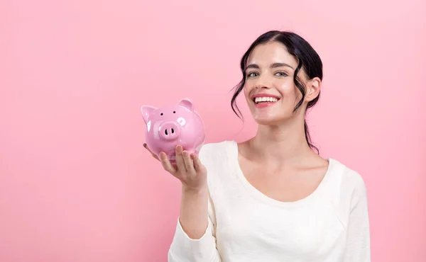 Mujer joven con una alcancía — Foto de Stock