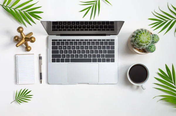 Laptop workstation with office supplies — ストック写真