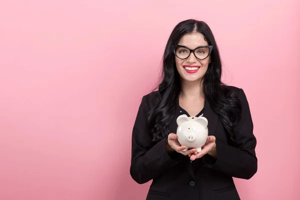 Young woman with a piggy bank — Stock Photo, Image