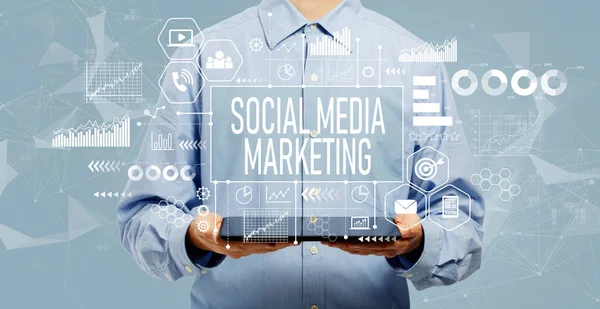 Social media marketing concept with man holding a tablet — ストック写真