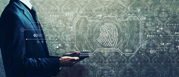 Fingerprint scanning theme with businessman holding a tablet — Stock Photo, Image