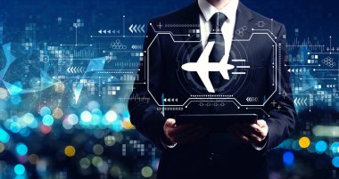 Bir tablet tutan işadamı ile uçak seyahat Tema