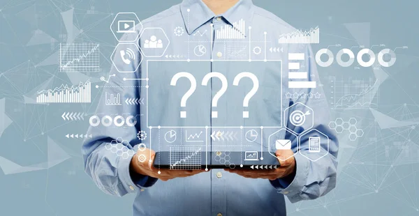 Question marks with man holding a tablet — Stock Photo, Image