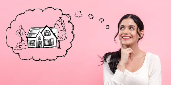 Dreaming of new home with young woman — Stock Photo, Image