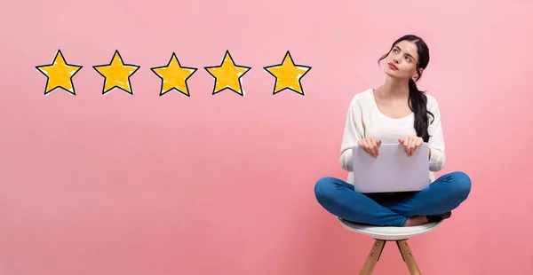 Five star rating with woman using a laptop — Stock Photo, Image