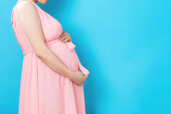Terhes nő szilárd háttérrel — Stock Fotó