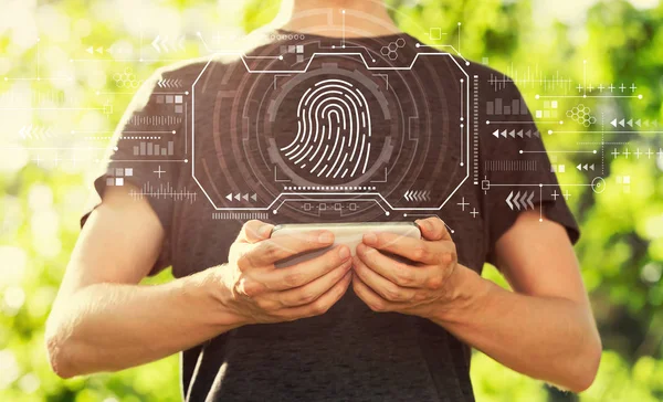 Fingerprint scanning theme with man holding his smartphone — Stock Photo, Image