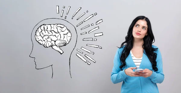 Brain illustration with woman holding a smartphone — 스톡 사진