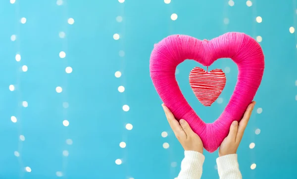 Young woman holding a big Valentines day heart — Stock Photo, Image