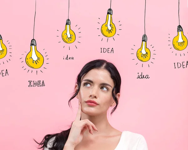 Idea light bulbs with young woman — Stock Photo, Image
