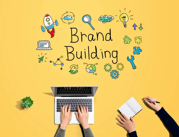 Brand building with people working together — 스톡 사진