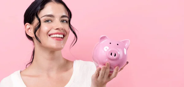 Young woman with a piggy bank — Stock Photo, Image