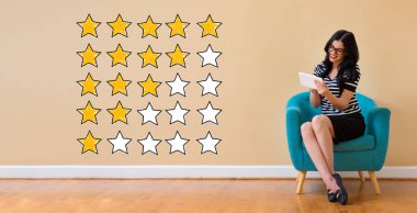 Rating with yellow stars with woman using a tablet