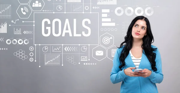 Goal concept with woman holding a smartphone — Stock Photo, Image