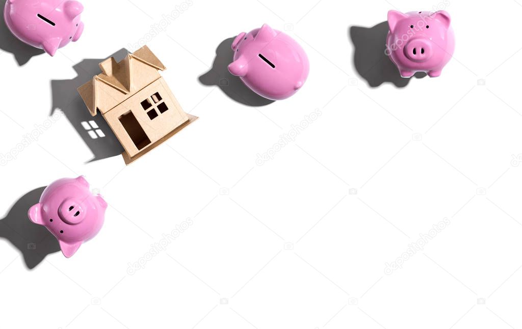 Miniature house with piggy banks