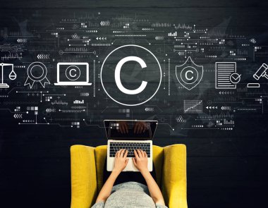 Copyright concept with person using a laptop clipart