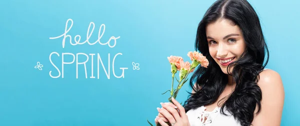 Hello spring message with young woman holding carnations — Stock Photo, Image