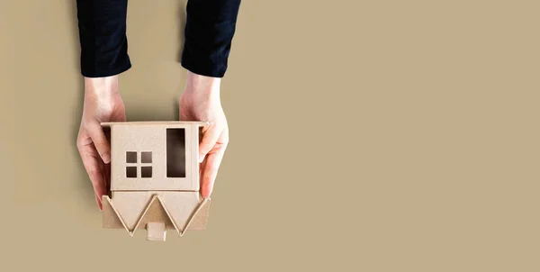 Woman holding a cardboard house — Stock Photo, Image