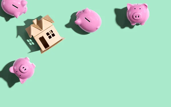 Miniature house with piggy banks — Stock Photo, Image