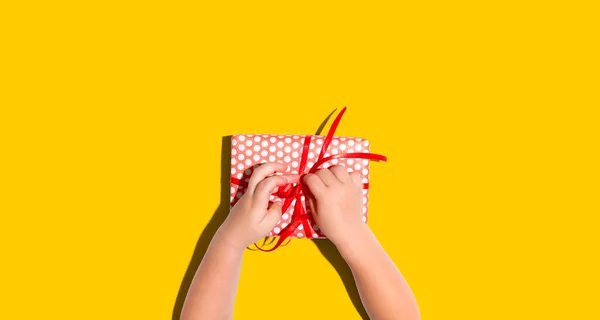 Little boy making a gift box from above — Stock Photo, Image