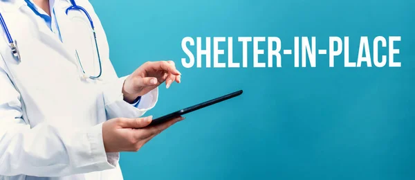 Shelter in place theme with a doctor using a tablet — Stock Photo, Image
