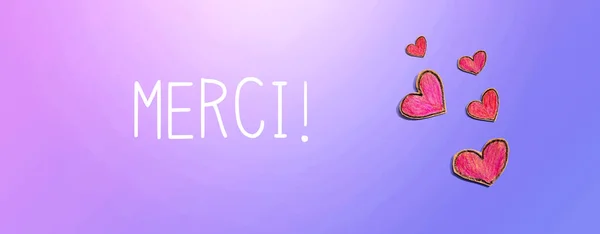 Merci - Gracias en francés con dibujos de corazón rojo — Foto de Stock