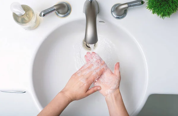 Person washing their hands at with soap and water — Stock Photo, Image