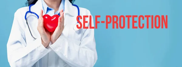 Self-protection theme with a doctor holding a heart — Stock Photo, Image