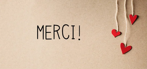 Merci - Thank you in French language with small hearts — Stock Photo, Image