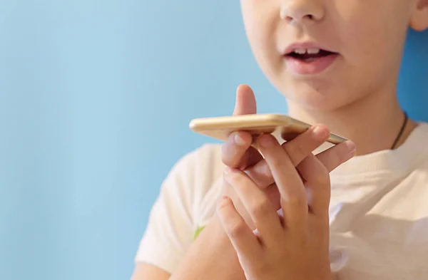 boy makes voice search on the smartphone, phone and gadget addiction