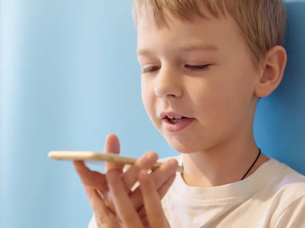 boy makes voice search on the smartphone, phone and gadget addiction