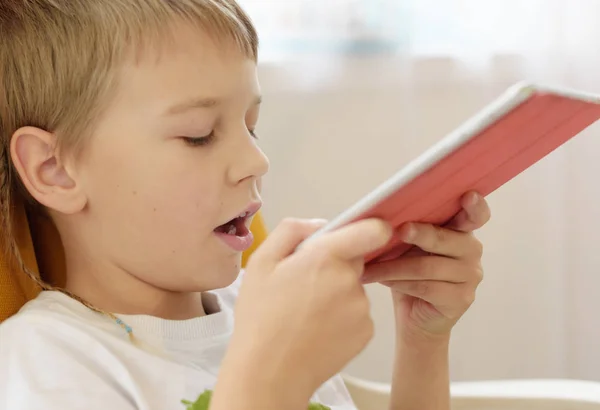 boy makes voice search on the smartphone, phone and gadget addiction