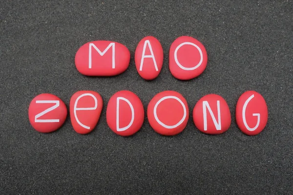 Mao Zedong, Chinese communist revolutionary who became the founding father of the People\'s Republic of China, creative celebration with red colored stone letters over black volcanic sand