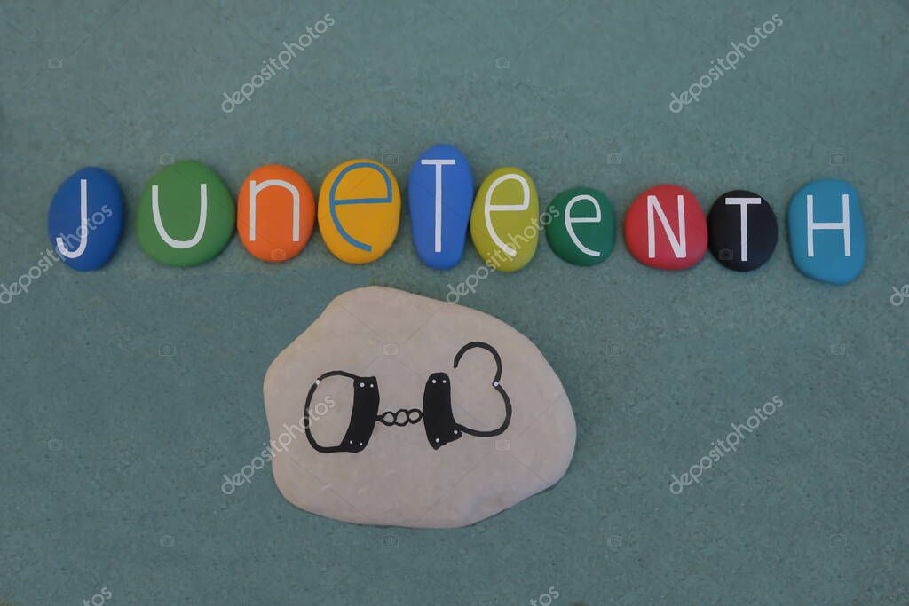 Juneteenth, the oldest nationally celebrated commemoration of the ending of slavery in the United States composed with multi colored stone letters over green sand
