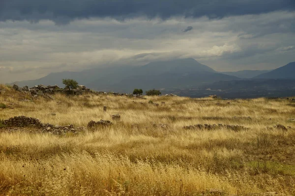 Dramatic landscape. Yellow grass, mountains. Turkey Pamukkale.