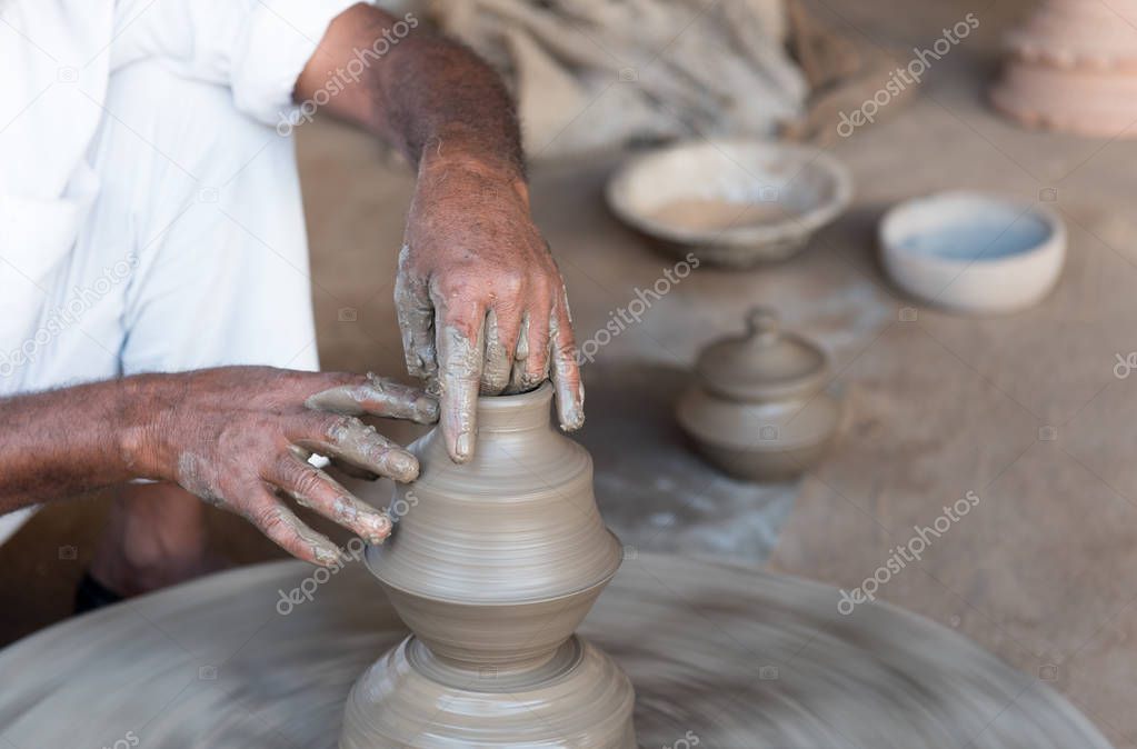 Man making handmade clay pottery