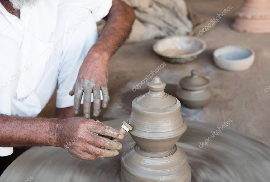 Man making handmade clay pottery