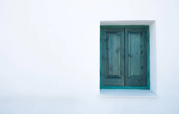 Green closed window on a white wall. — Stock Photo, Image