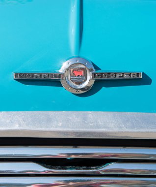 Morris Cooper mavi boyalı araba yüzeyinde eski model bir araba logosu.