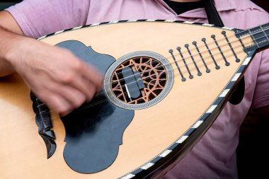 Müzisyen laouto ile geleneksel bir şarkı çalıyor.