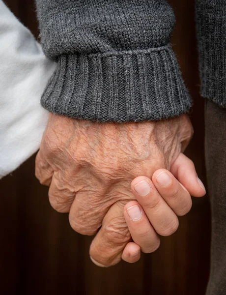 Elder senior adult and you child holding hands. — Stock Photo, Image