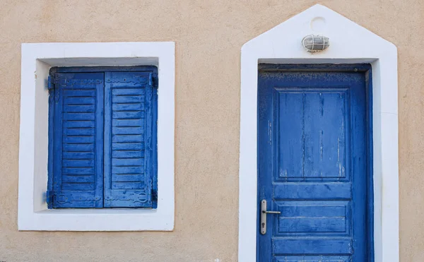 Traditional Greek island blue door and window with a white frame — Stock Photo, Image