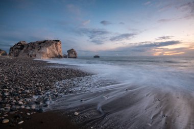 Seascape with windy waves and moody sky during sunset