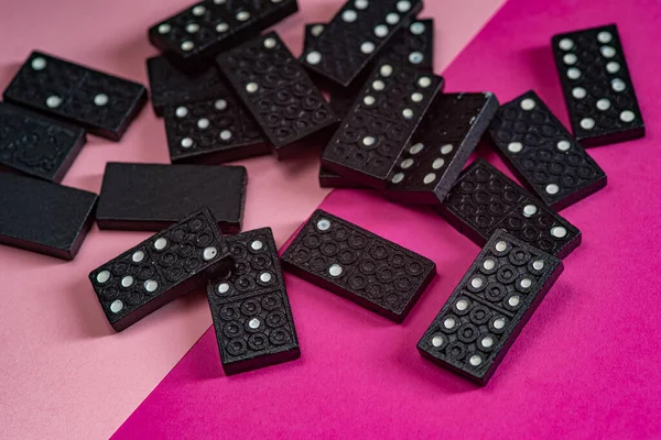Black Dominoes game block on a colored background