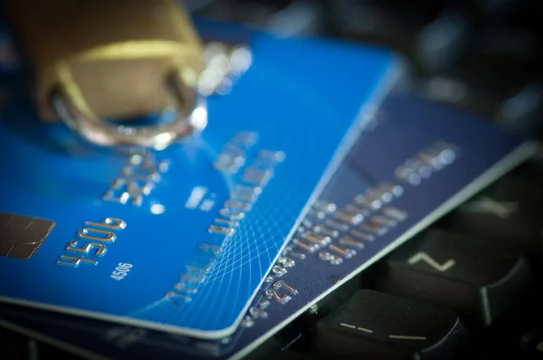 Close-up details of credit cards on a computer keyboard. Plastic electronic money and secure transactions