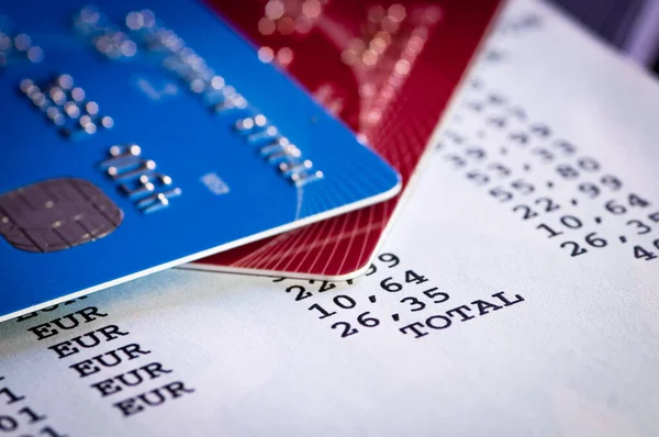 Close-up details of credit cards on an expenses report. Plastic money expenses.