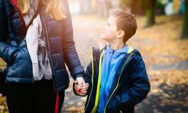 Yürüyüş sırasında annesi elini tutan çocuk