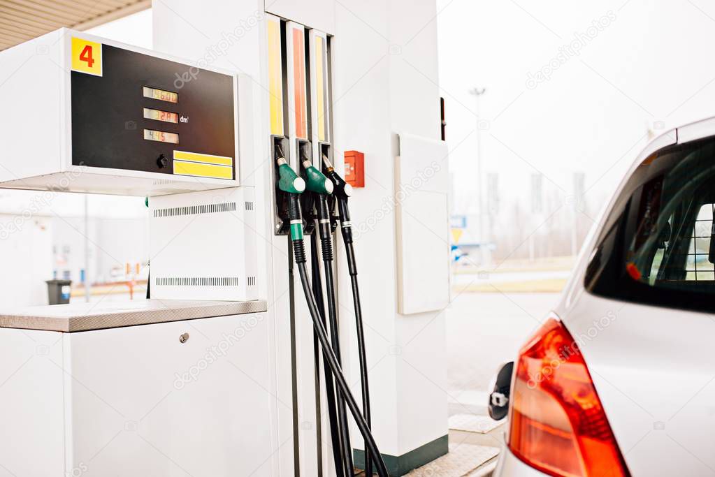 Silver car refuelling at the gas station