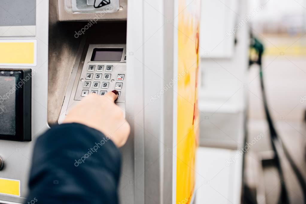 Woman paying with credit card for fuel