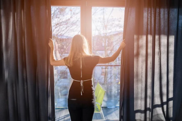 Hotel maid opening window curtains — Stock Photo, Image